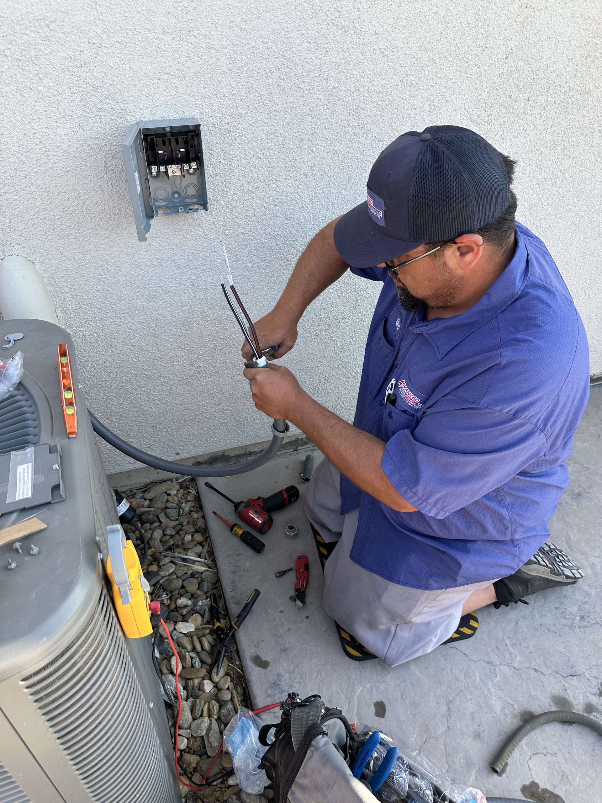 HVAC tech doing electrical installation for heat pump