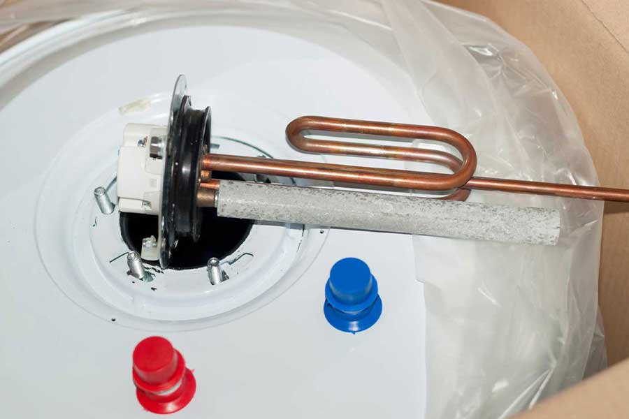 Commercial water heater repair showing copper heating element and tank components