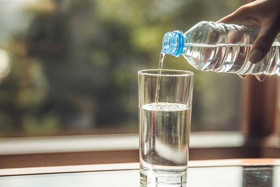 Clean water being poured into a glass for water quality testing in Vacaville, CA