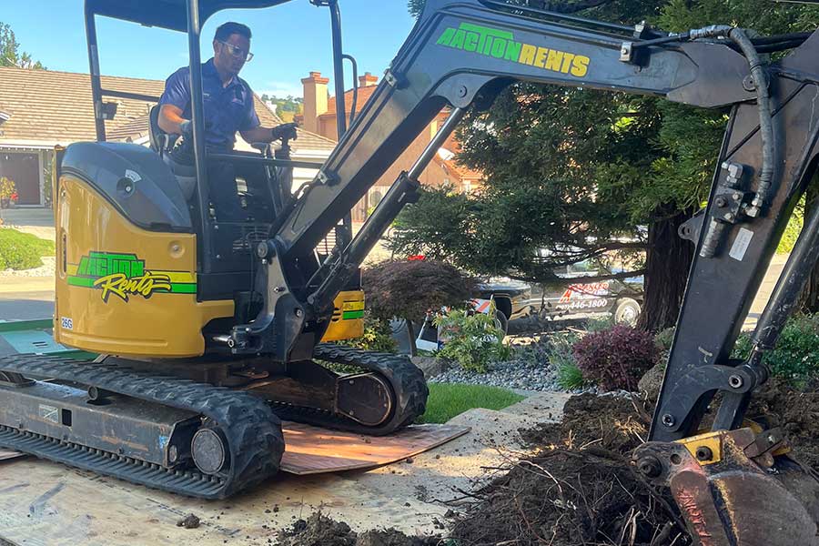 Plumber excavating a residential yard for underground plumbing repair in Vacaville, CA