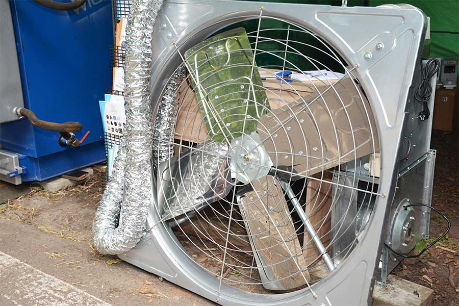 Residential attic fan installation showing large fan equipment and vent connections