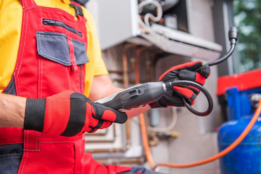 Technician inspecting gas equipment with an electronic detector for gas leak repair in Vacaville, CA
