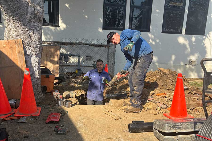 Two Advanced plumbers working in an excavated area during underground plumbing repair in Vacaville, CA