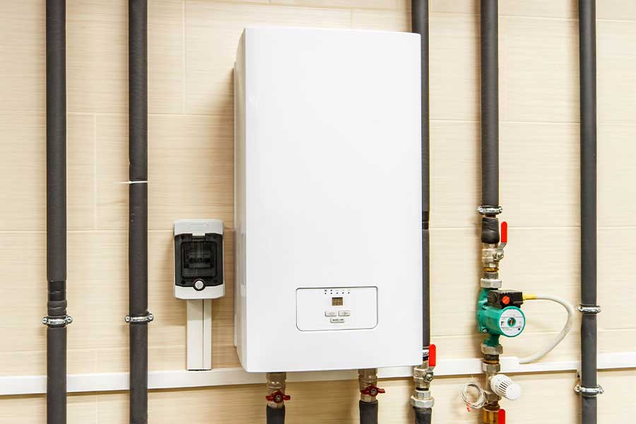 Wall-mounted commercial water heater with visible pipe and valve connections in Vacaville CA