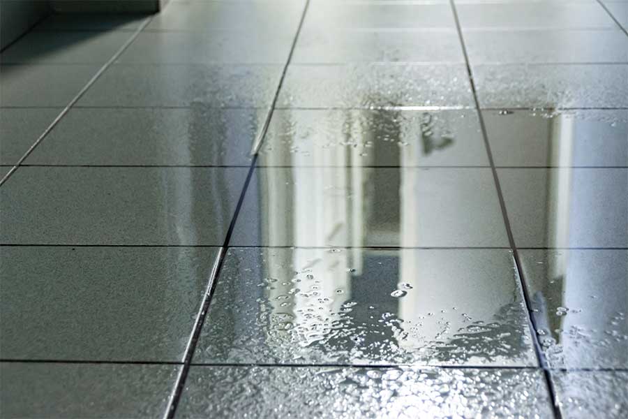 Standing water on a home's tile floor requiring an emergency plumber in Vacaville, CA
