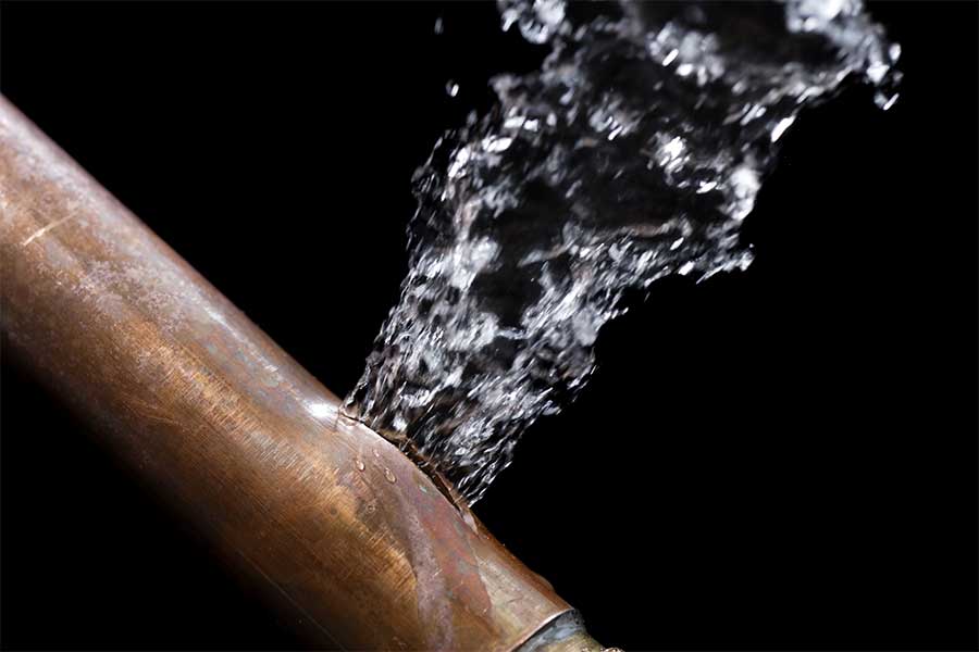 Burst water pipe causing an emergency plumbing repair