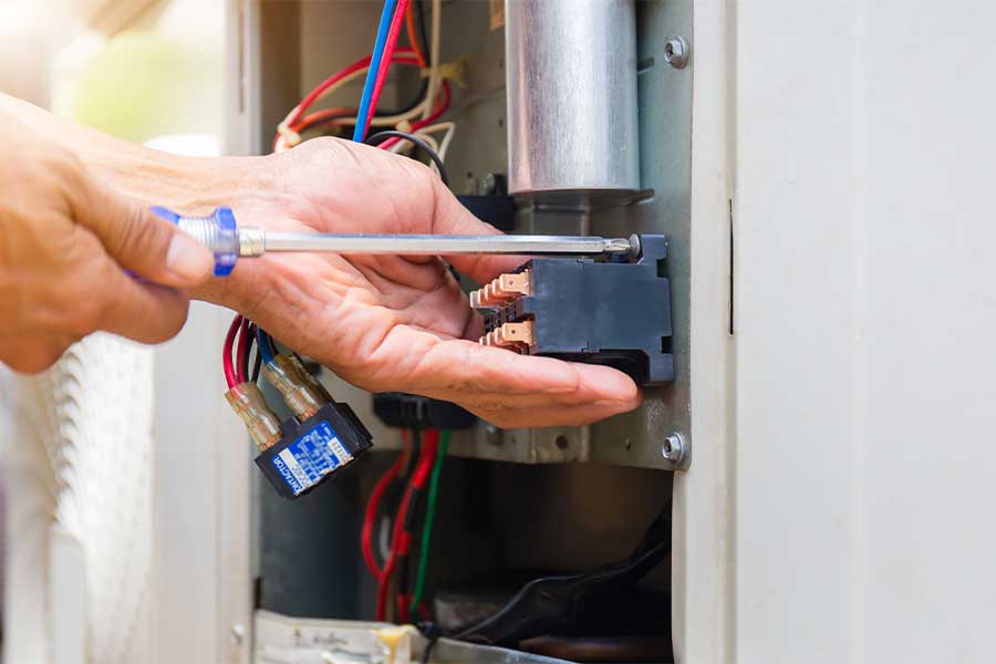 Technician replacing a faulty furnace part during a repair in Vacaville, CA