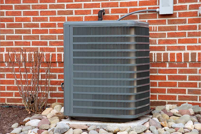 Residential heat pump inspected during scheduled maintenance