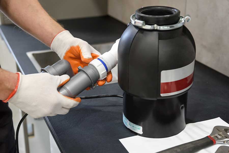 Installing a garbage disposal with drain pipes connected under a kitchen sink