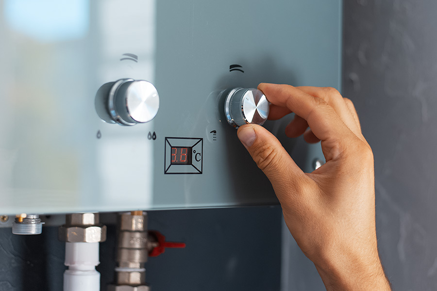 Commercial tankless water heater controls being checked during repair service in Vacaville, CA